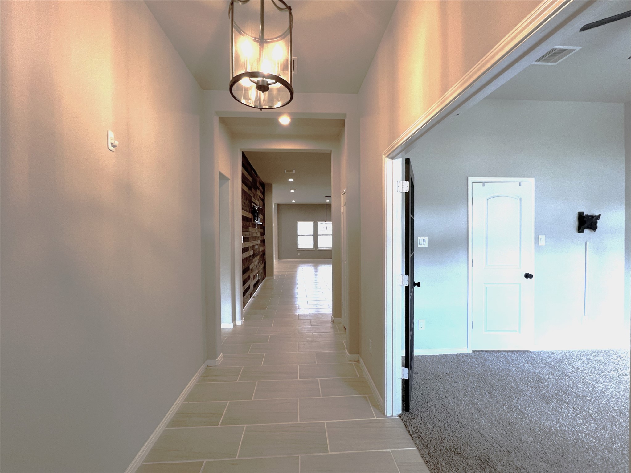 14208 Wallowa Ridge Lane Conroe, TX 77384 - Photo 5 of 48 a view of a hallway with wooden floor and chandelier