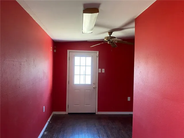 a view of a room with wooden floor and a window