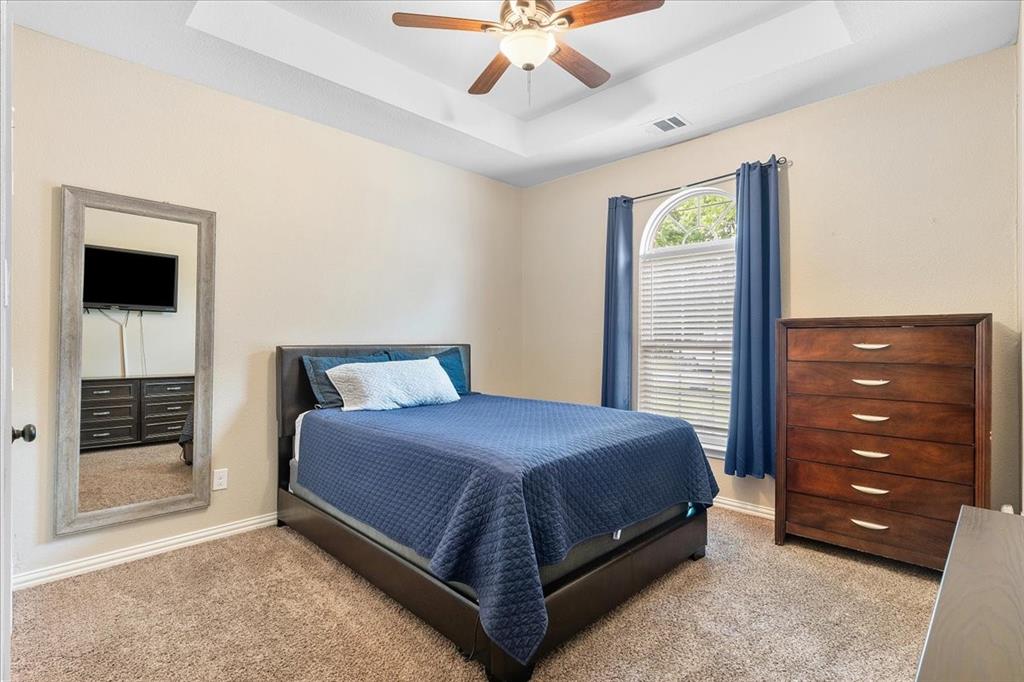 502 Ritchey Street Gainesville, TX 76240 - Photo 6 of 29 a bedroom with a bed and a ceiling fan