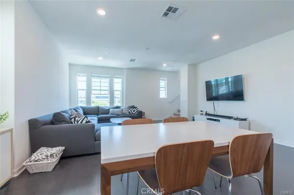 a kitchen with stainless steel appliances granite countertop a sink refrigerator and cabinets