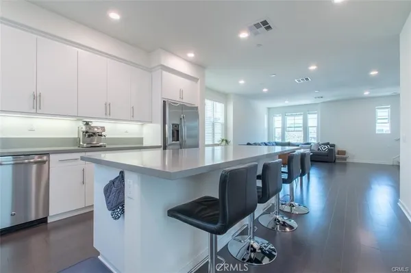 a large white kitchen with a large window