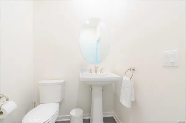 a spacious bedroom with a bed and a flat tv screen on the dresser