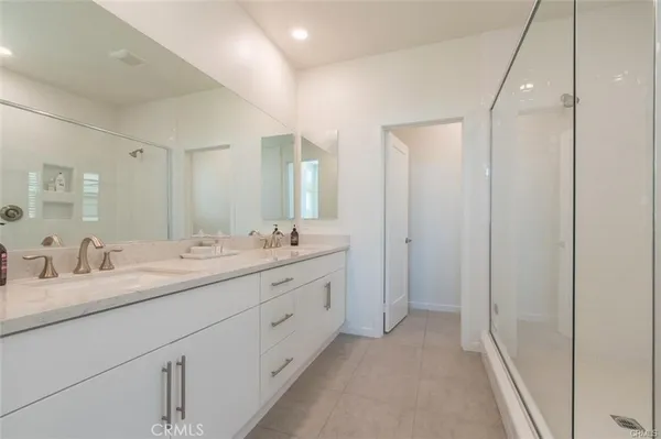 a bathroom with a shower and a glass door