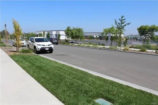 a view of a garden with a building in the background