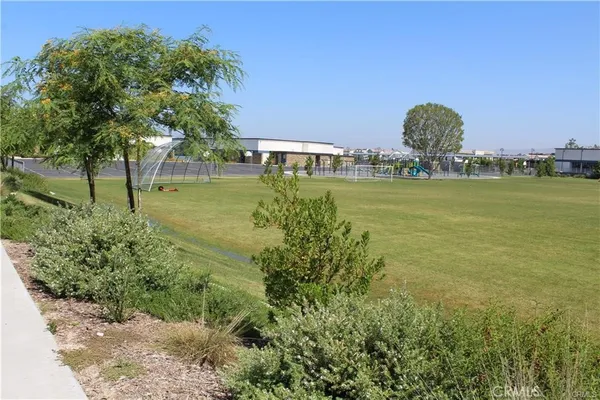 a view of a garden with a building in the background