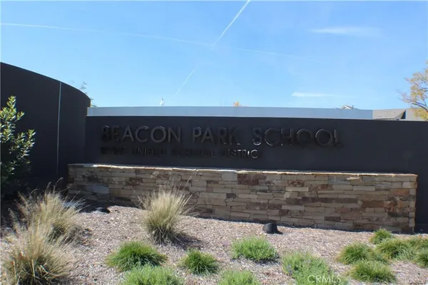 a sign broad in front of the red brick house