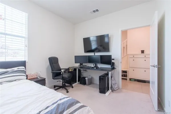 a bedroom with a bed and window