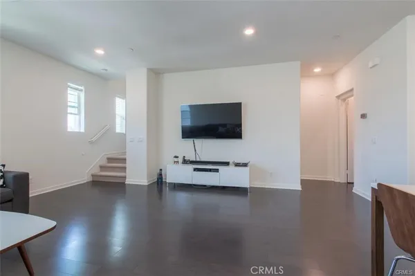 a living room with furniture and view of kitchen