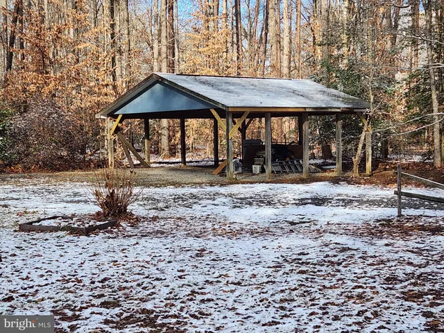 a backyard of a house with barbeque oven table and chairs