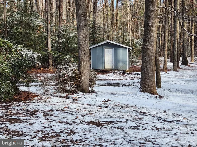 a view of a house with a yard covered in snow