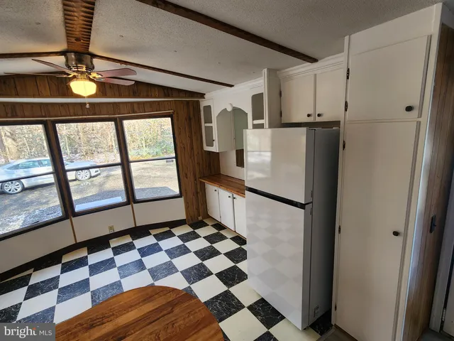 a kitchen with a sink a stove cabinets and a dining table