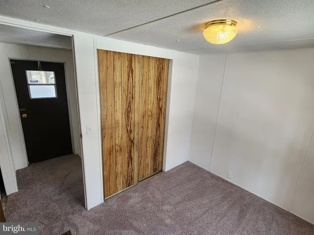 a view of hallway with stairs and wooden floor