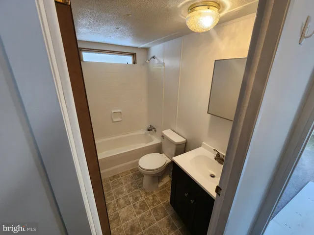 a bathroom with a sink toilet and mirror