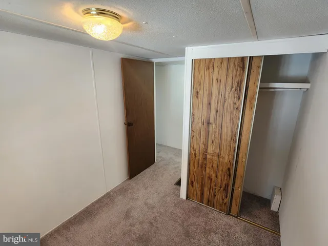 an empty room with windows and closet