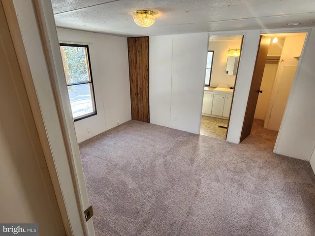 an empty room with windows and closet