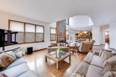 a kitchen with stainless steel appliances granite countertop a stove top oven a sink dishwasher and cabinets with wooden floor