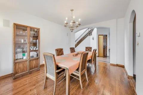 a dining room with furniture and wooden floor