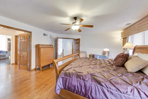 a bedroom with a large bed and a dresser
