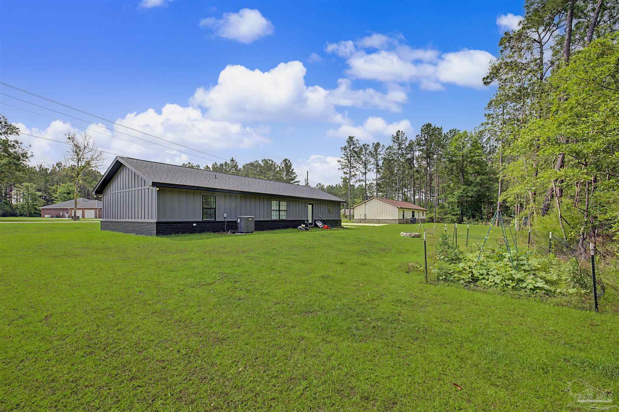 2549 Ten Mile Road Pace, FL 32571 - Photo 35 of 46 a view of a house with a big yard