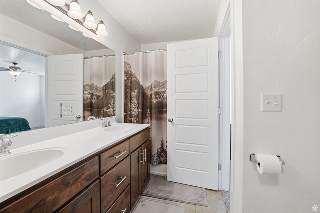 1024 South 270 West Logan, UT 84321 - Photo 18 of 37 Ensuite bathroom featuring double vanity, a shower with curtain, and a ceiling fan