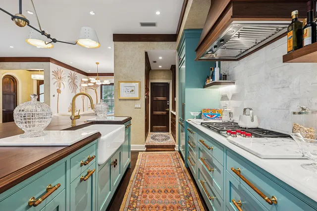 a living room with furniture a rug and a chandelier