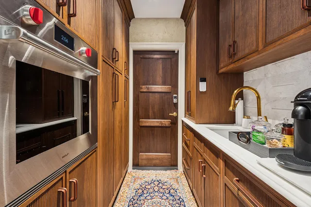 a spacious bathroom with a granite countertop sink and a large mirror
