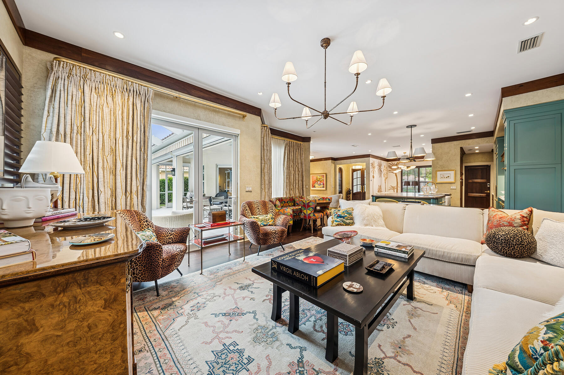 7718 Spring Creek Drive West Palm Beach, FL 33411 - Photo 18 of 72 a living room with furniture a rug and a chandelier