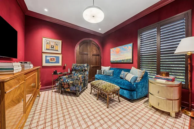 a dining room with furniture and a floor to ceiling window