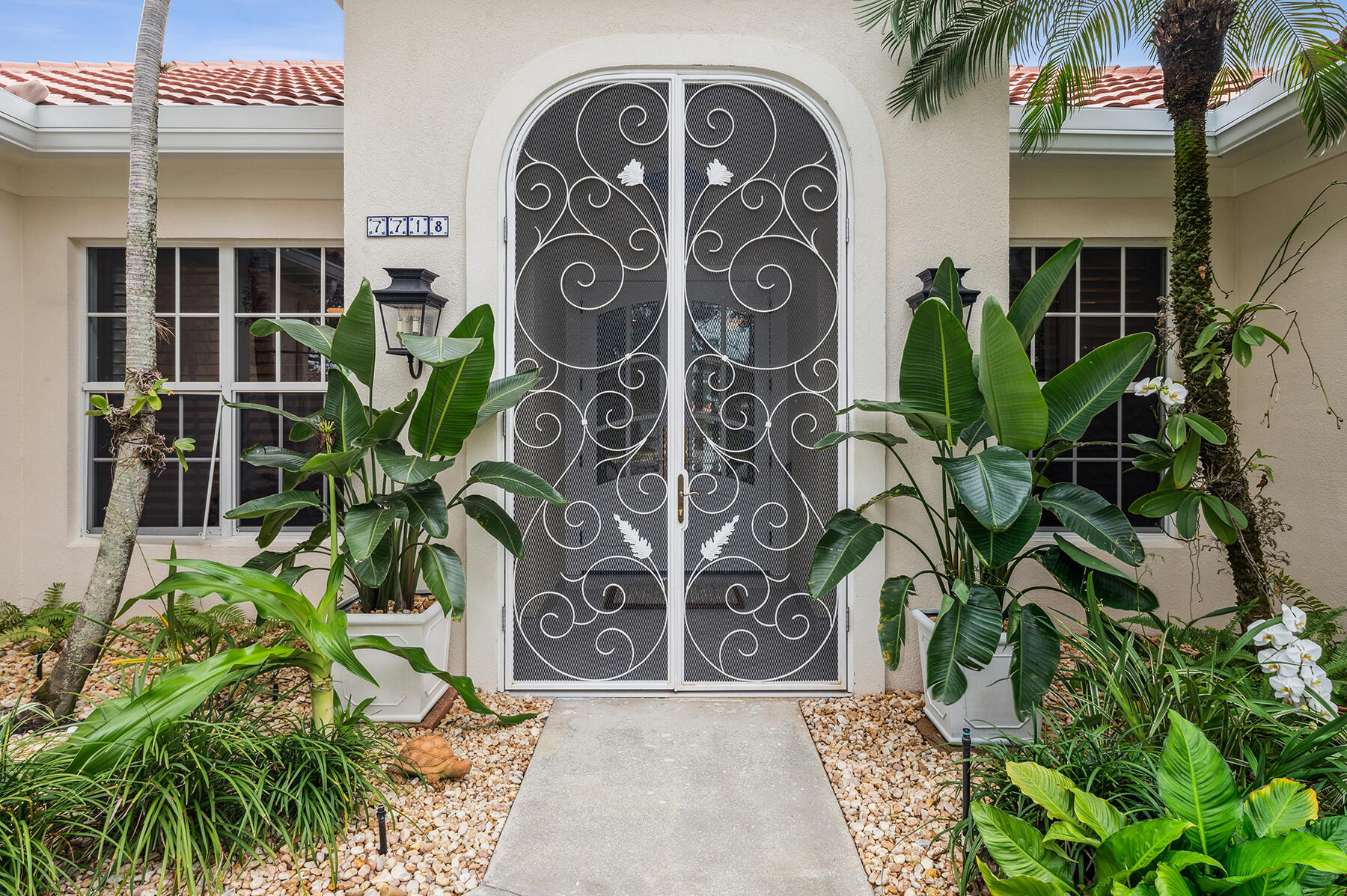7718 Spring Creek Drive West Palm Beach, FL 33411 - Photo 3 of 72 a view of front door with potted plants