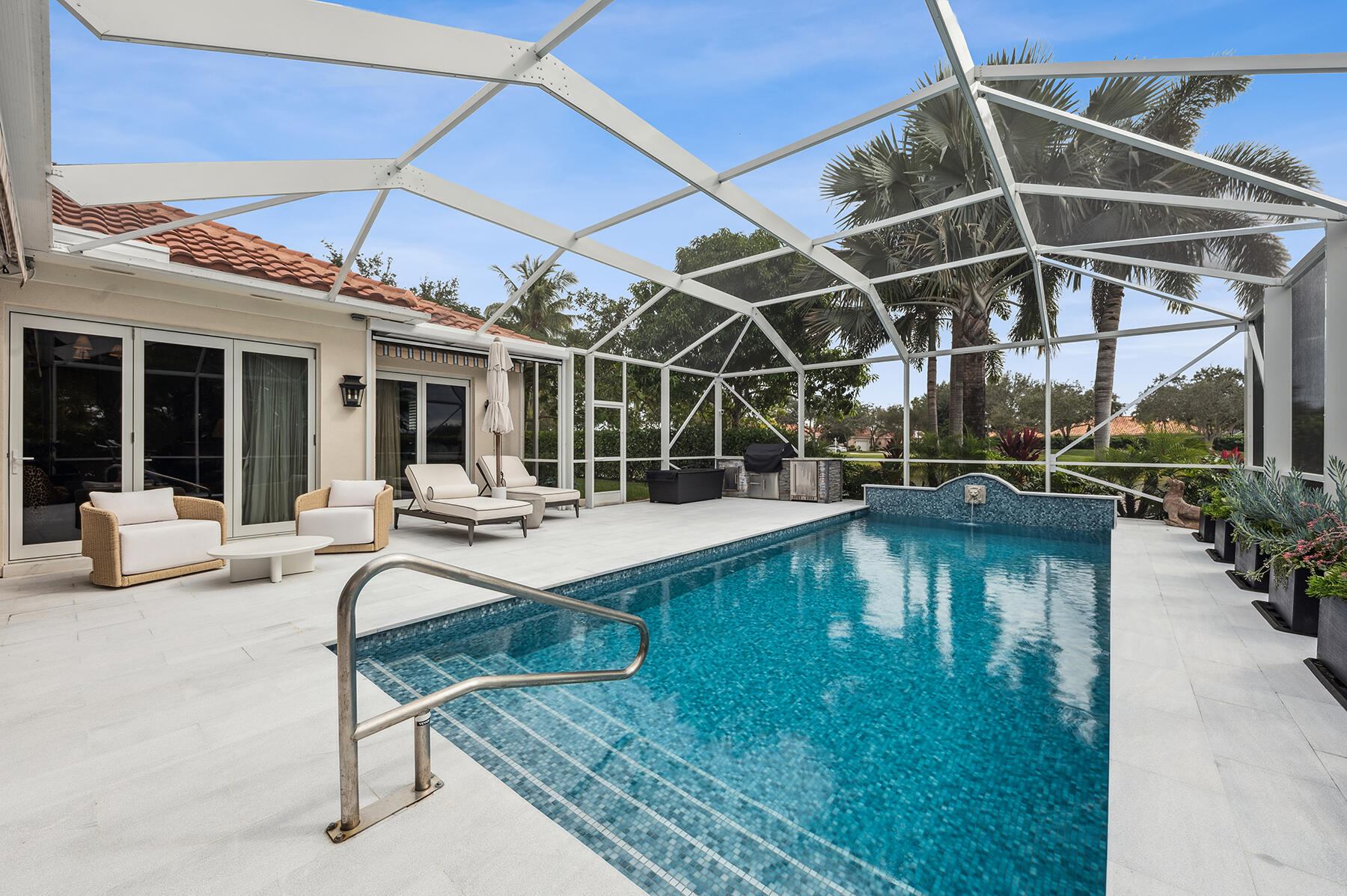 7718 Spring Creek Drive West Palm Beach, FL 33411 - Photo 35 of 72 a view of a swimming pool with a patio