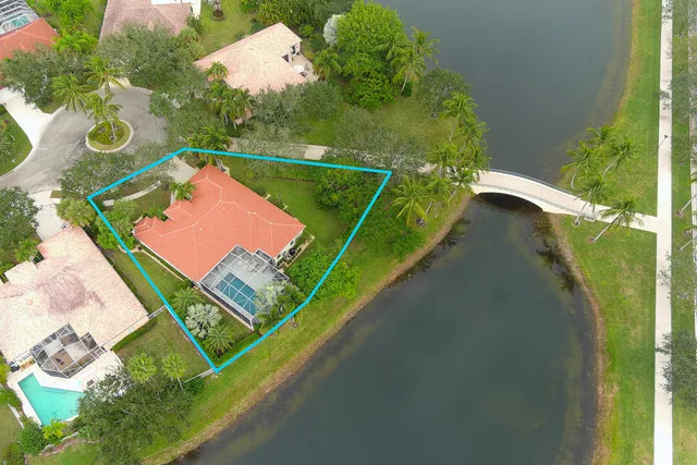 a view of a patio with a table and chairs under an umbrella