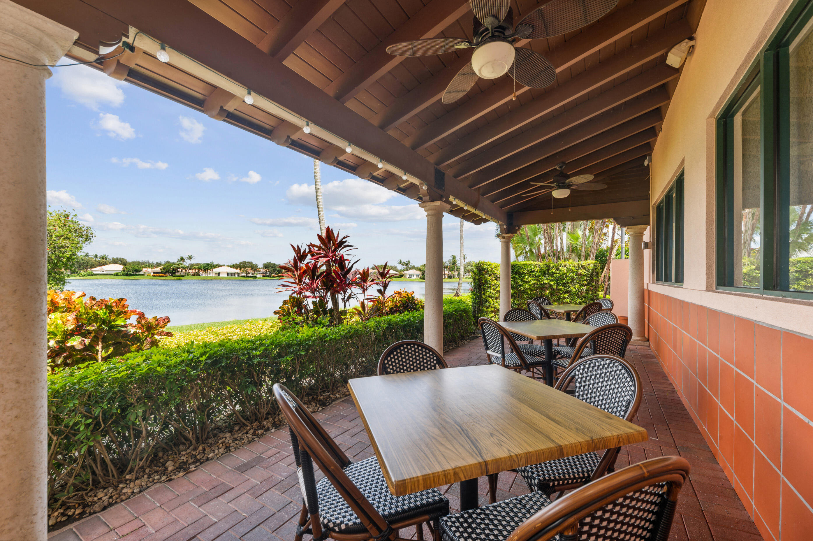 7718 Spring Creek Drive West Palm Beach, FL 33411 - Photo 52 of 72 a view of a patio with a table and chairs