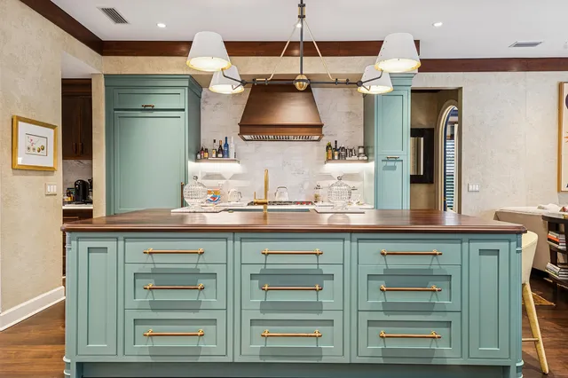 a large kitchen with stainless steel appliances granite countertop a stove and a sink