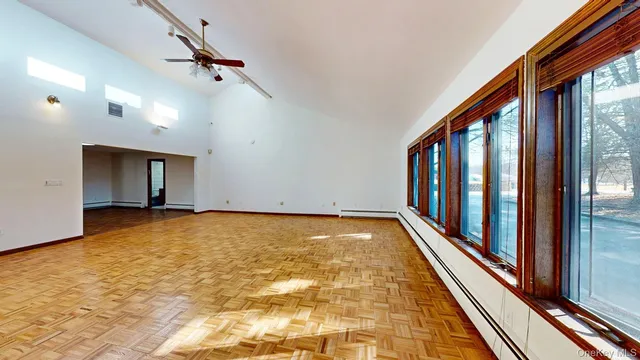 a living room with furniture and floor to ceiling window
