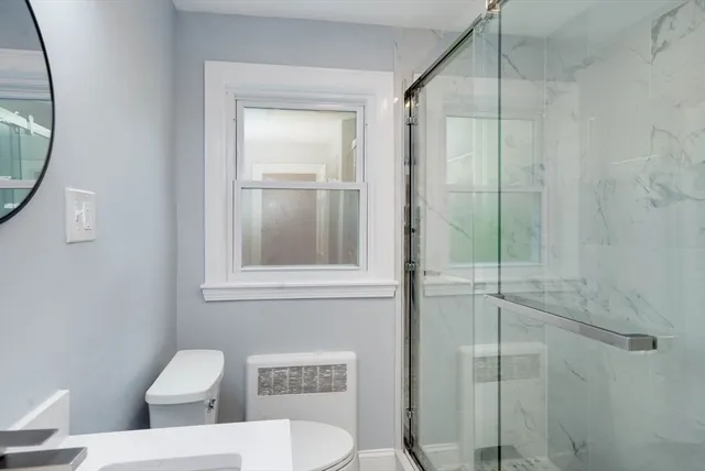 a room with a sink cabinets and a window