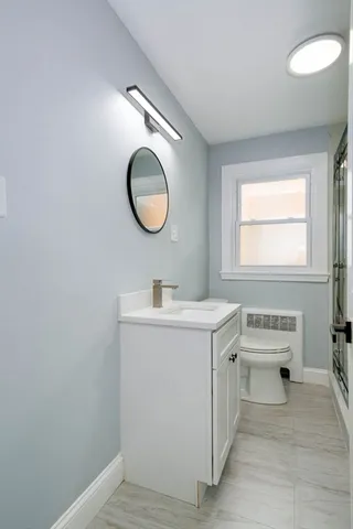 a bathroom with a sink vanity and a mirror