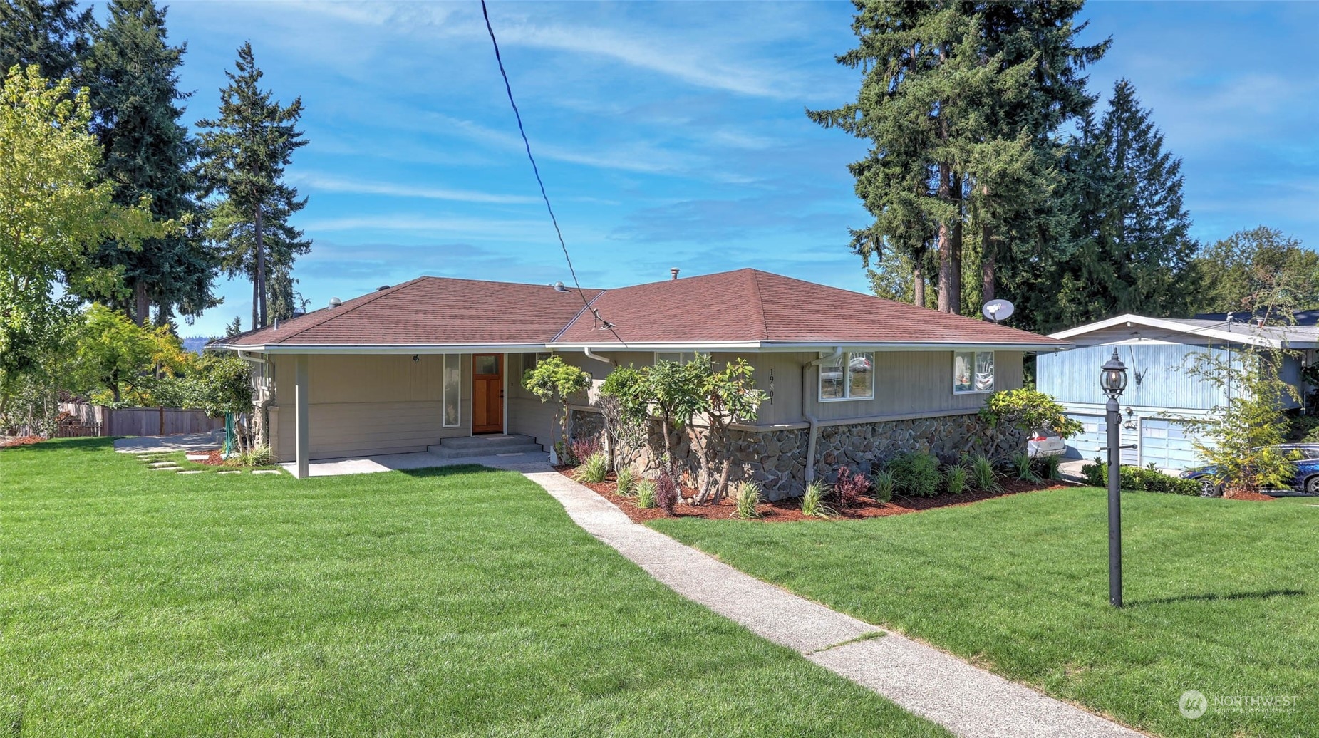 19801 Talbot Road South Renton, WA 98055 - Photo 1 of 20 a front view of a house with garden