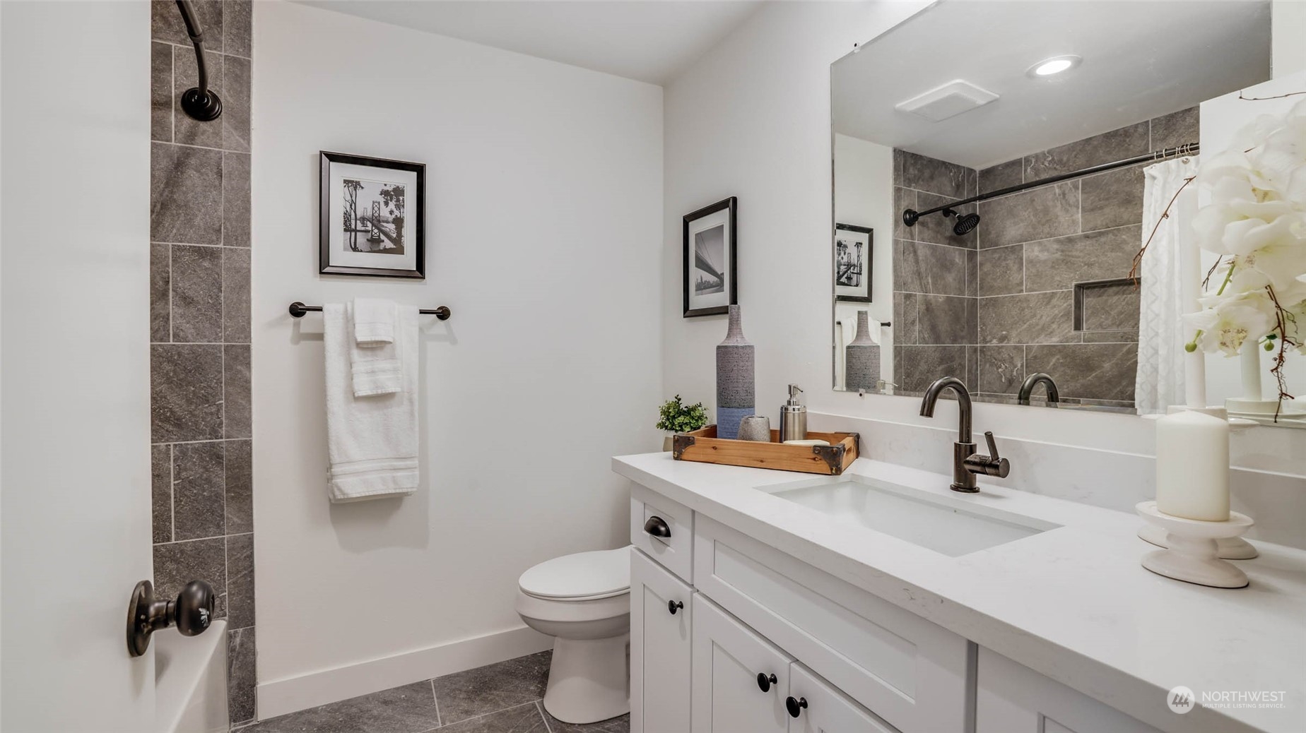 19801 Talbot Road South Renton, WA 98055 - Photo 11 of 20 a bathroom with a sink toilet and shower
