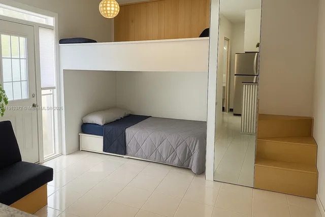 a bedroom with a bed and a couch