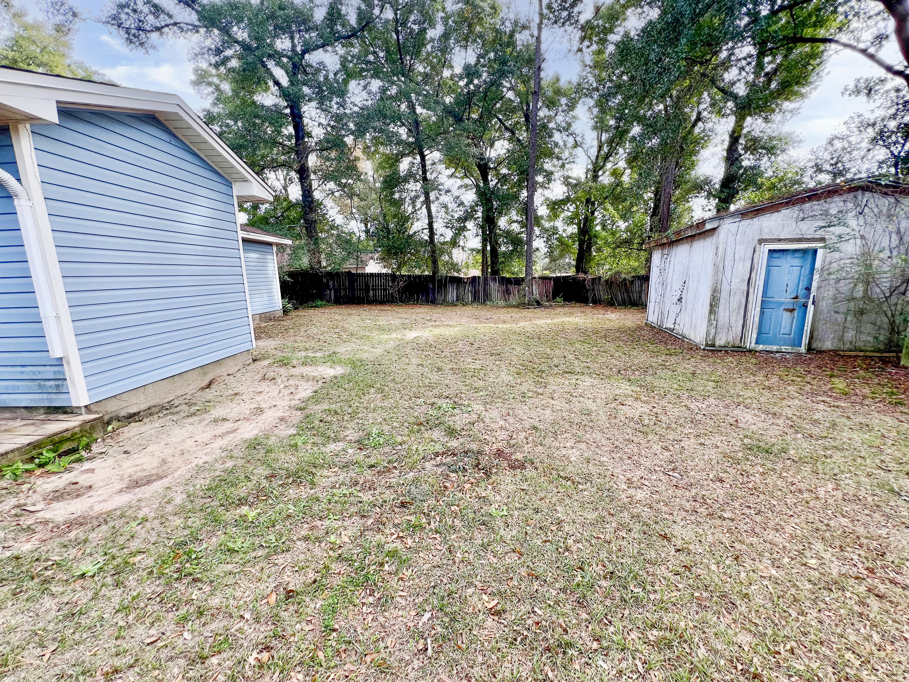 401 Cornwall Circle Pensacola, FL 32514 - Photo 15 of 20 a view of a backyard with large trees and a small barn