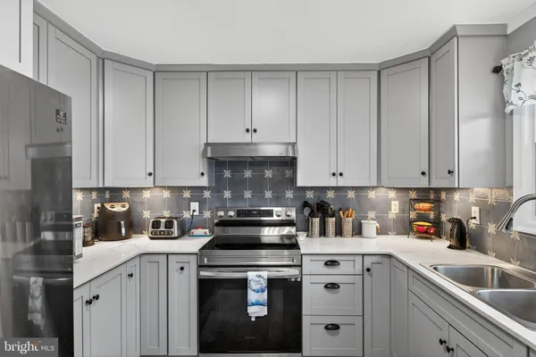 a kitchen with a sink and cabinets