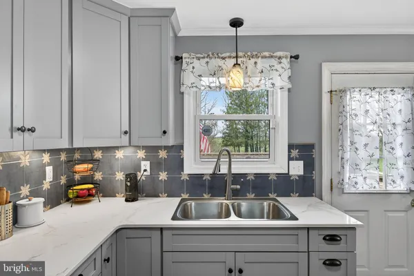 a kitchen that has a sink and a large window