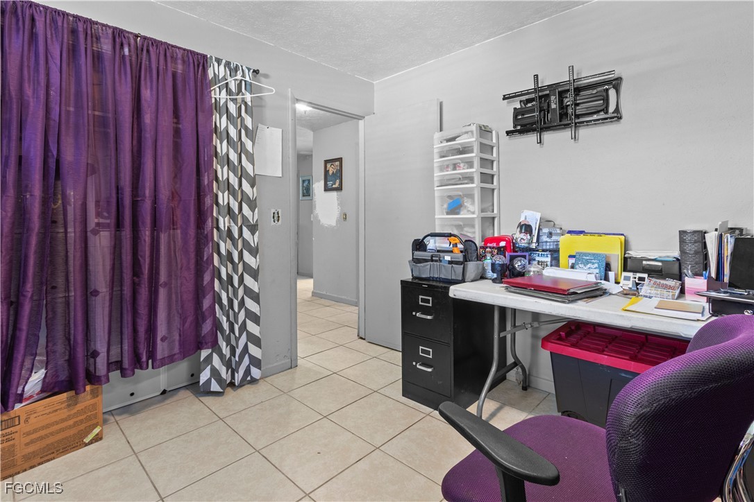 117 Texas Road Lehigh Acres, FL 33936 - Photo 13 of 19 a room with a table chairs and a window