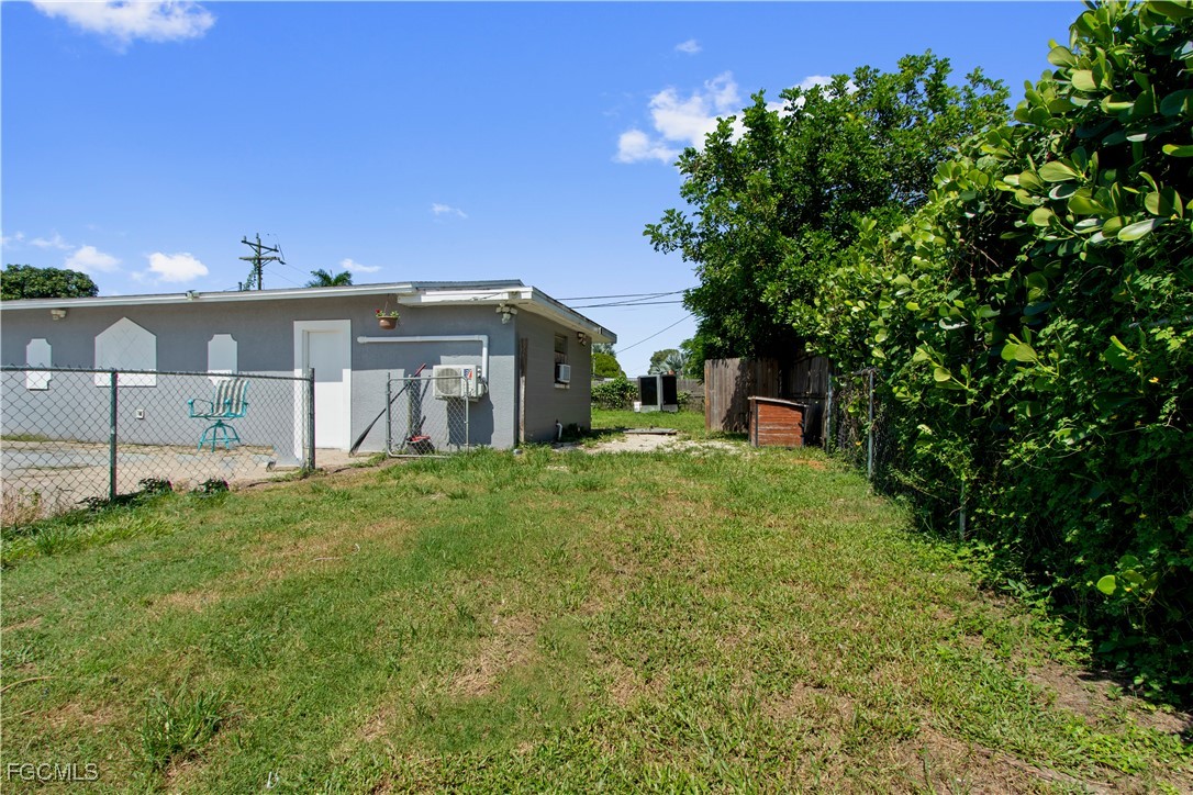 117 Texas Road Lehigh Acres, FL 33936 - Photo 15 of 19 a view of a house with a yard