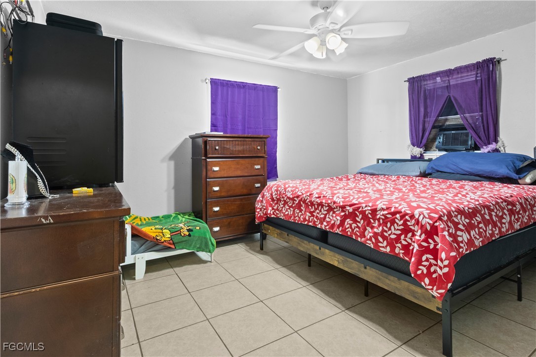 117 Texas Road Lehigh Acres, FL 33936 - Photo 7 of 19 a bedroom with a bed and dresser