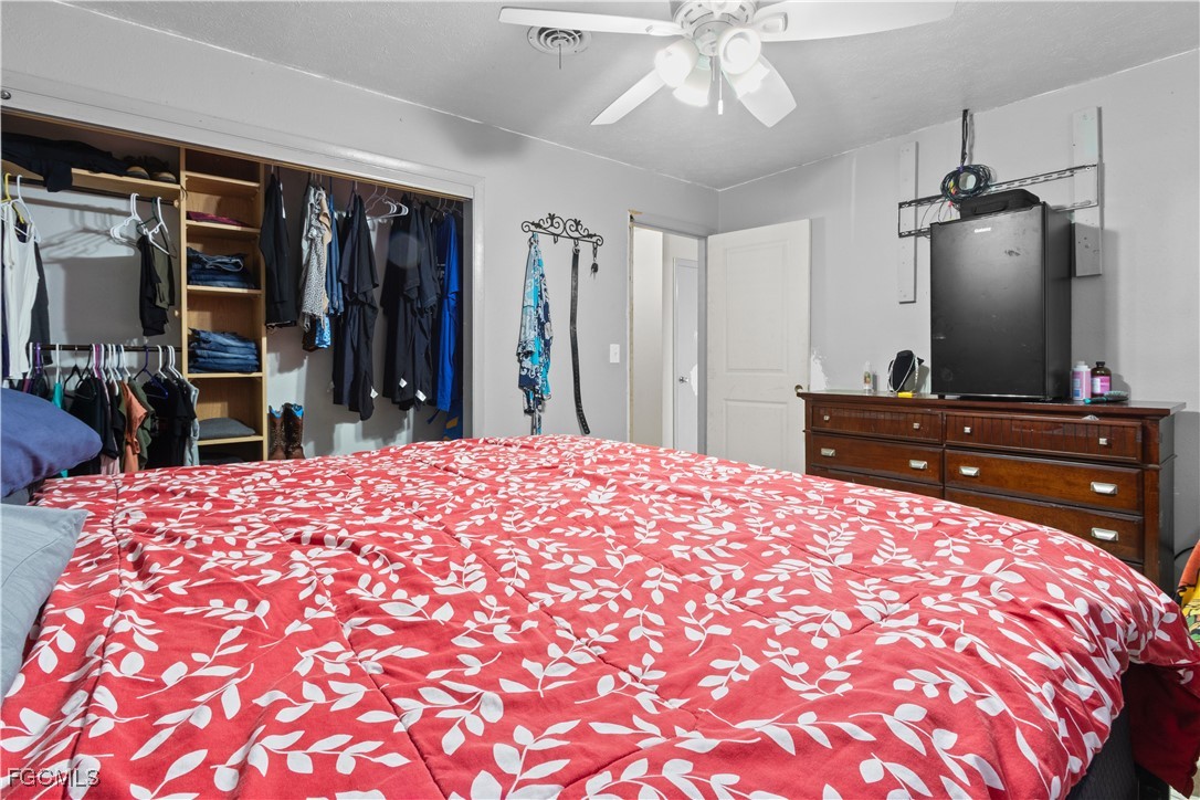 117 Texas Road Lehigh Acres, FL 33936 - Photo 8 of 19 a bed room with a bed and a television