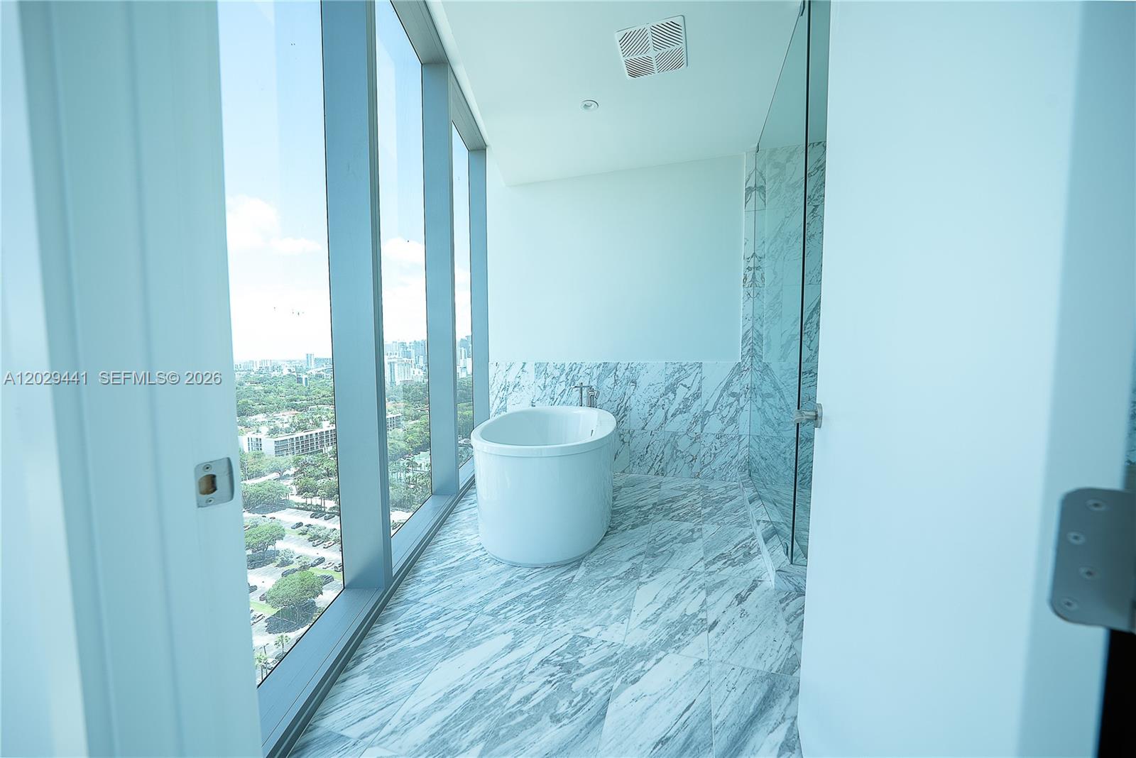 175 Southeast 25th Road, Unit 2103 Miami, FL 33129 - Photo 17 of 27 a bathroom with a toilet and a shower