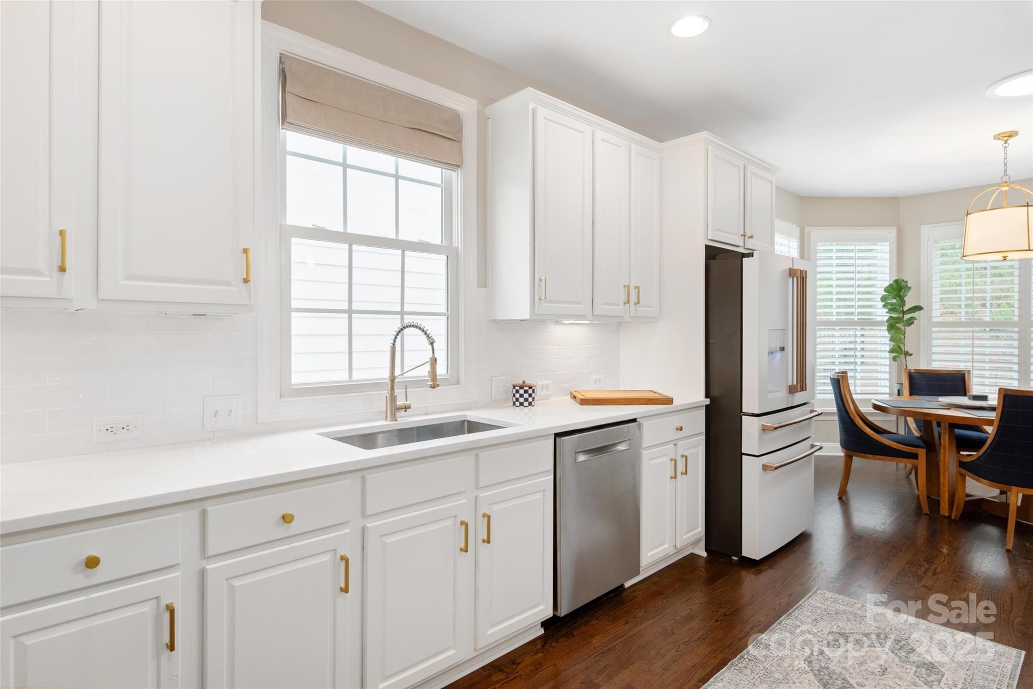 875 Stratford Run Drive Fort Mill, SC 29708 - Photo 2 of 37 a kitchen with white cabinets and white appliances