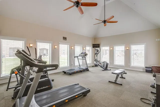 a room with gym equipment and windows