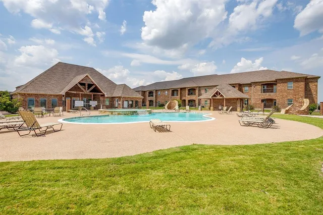 a swimming pool with outdoor seating and yard
